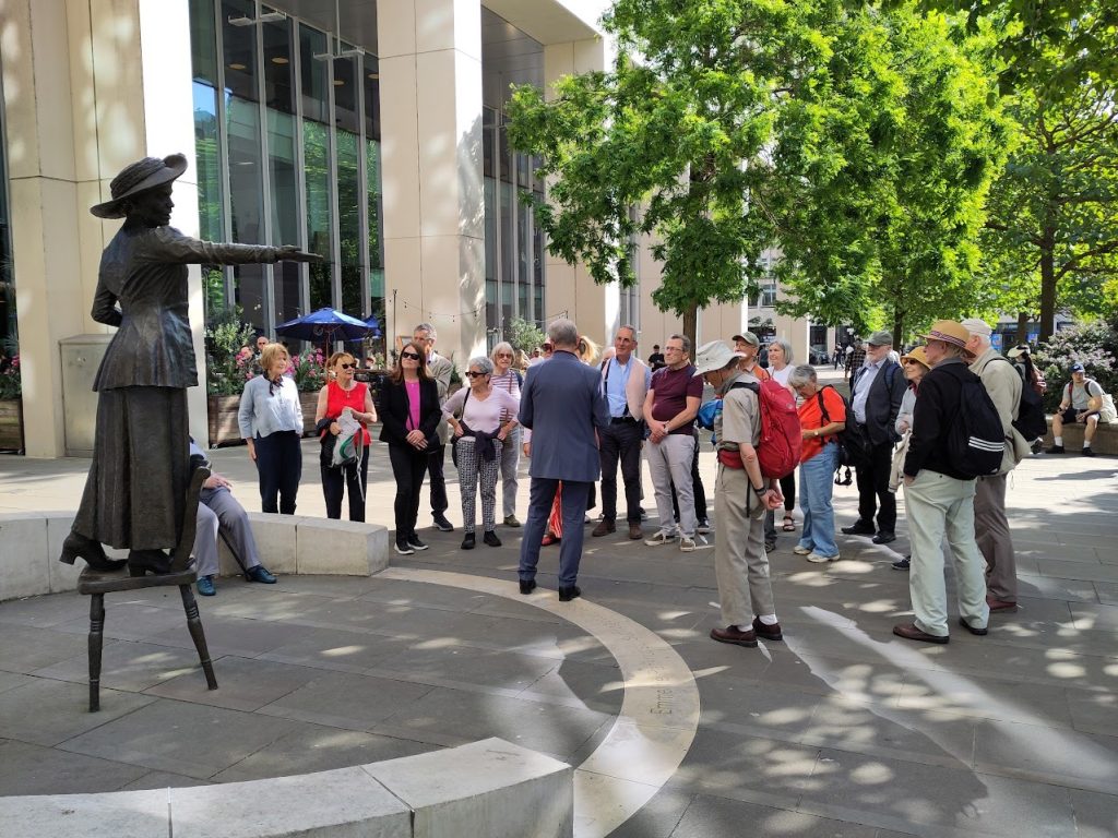 Members of the Society looking at the statue of Emmeline Pankhurst.